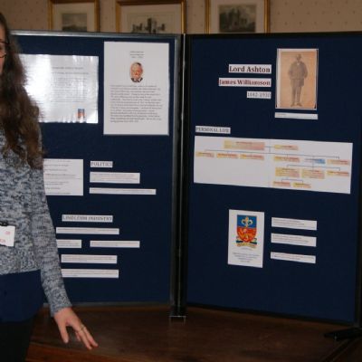 Volunteer Hannah with Lord Ashton Display Board